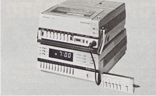 Hitachis kompakte, bærbare opptaker (her plassert på toppen av den tilhørende TV-tuner for stasjonært bruk) har touchbetjening og veier bare 6,8 kg med batteri. Bilde fra Radiobransjen nr. 10/1979. Hitachis kompakte, bærbare opptaker (her plassert på toppen av den tilhørende TV-tuner for stasjonært bruk) har touchbetjening og veier bare 6,8 kg med batteri. Bilde fra Radiobransjen nr. 10/1979.